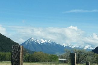 Fence Post And Mountains In Montana
