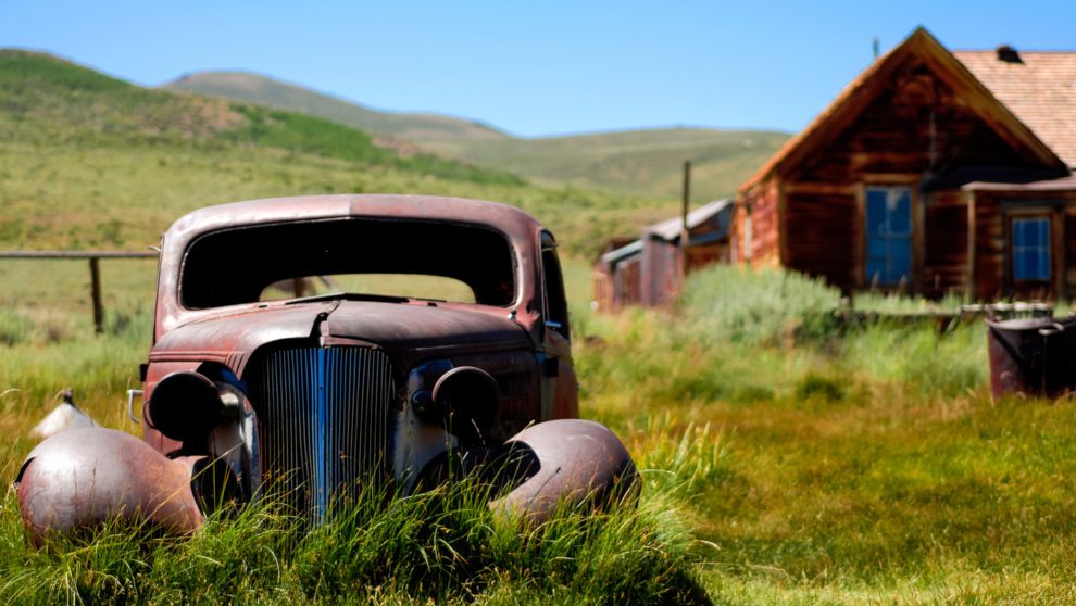 Abandoned Car in Front of a Barn